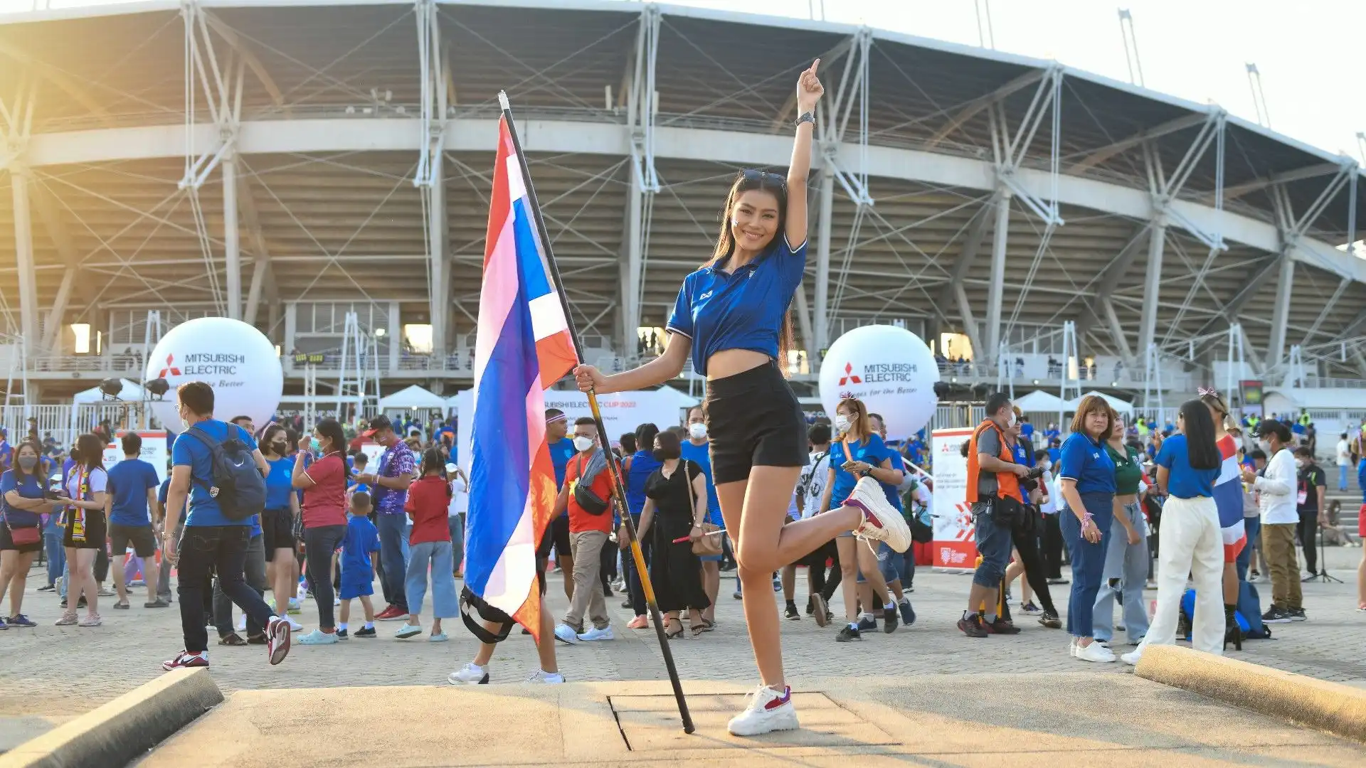 Una tifosa thailandese posa davanti allo stadio