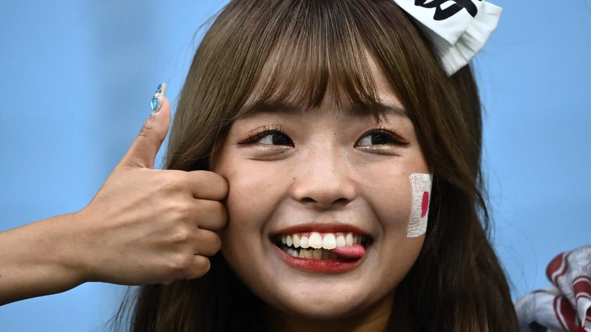 I fotografi sono sempre bravissimi ad immortalare i sorrisi dei tifosi giapponesi