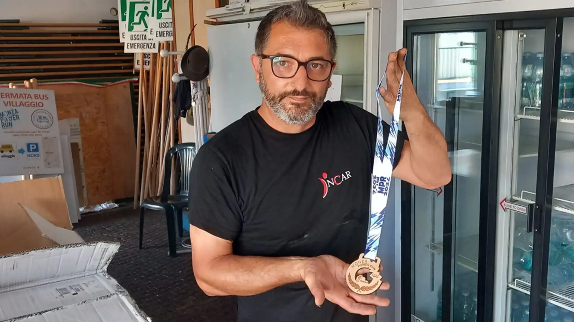 Il capo villaggio Stefano Fontana mostra fiero la medaglia di legno del 2024